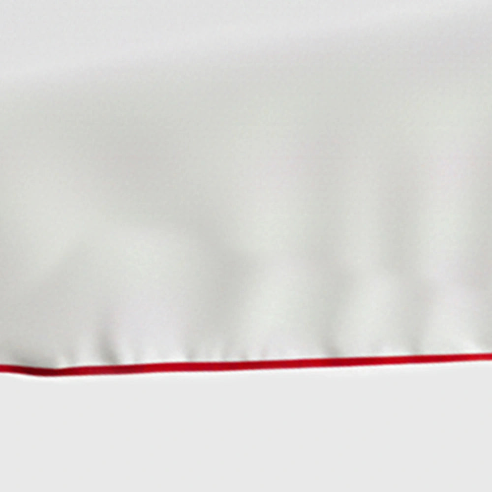 White cotton tablecloth with magenta scalloped piping trim on rectangular dining table White cotton tablecloth with magenta scalloped piping trim on rectangular dining table