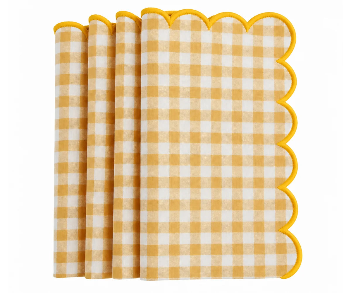 A stack of Yellow and white gingham check paper napkins with scalloped edges, shown on a clean white background. A stack of Yellow and white gingham check paper napkins with scalloped edges, shown on a clean white background.