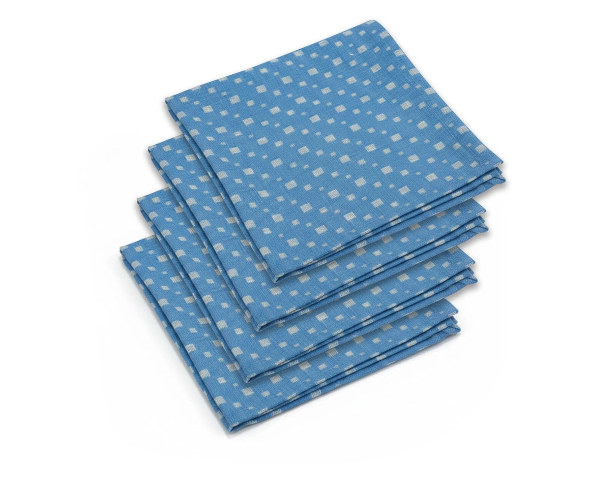 Stack of blue printed cotton cloth napkins with small white pattern Stack of blue printed cotton cloth napkins with small white pattern