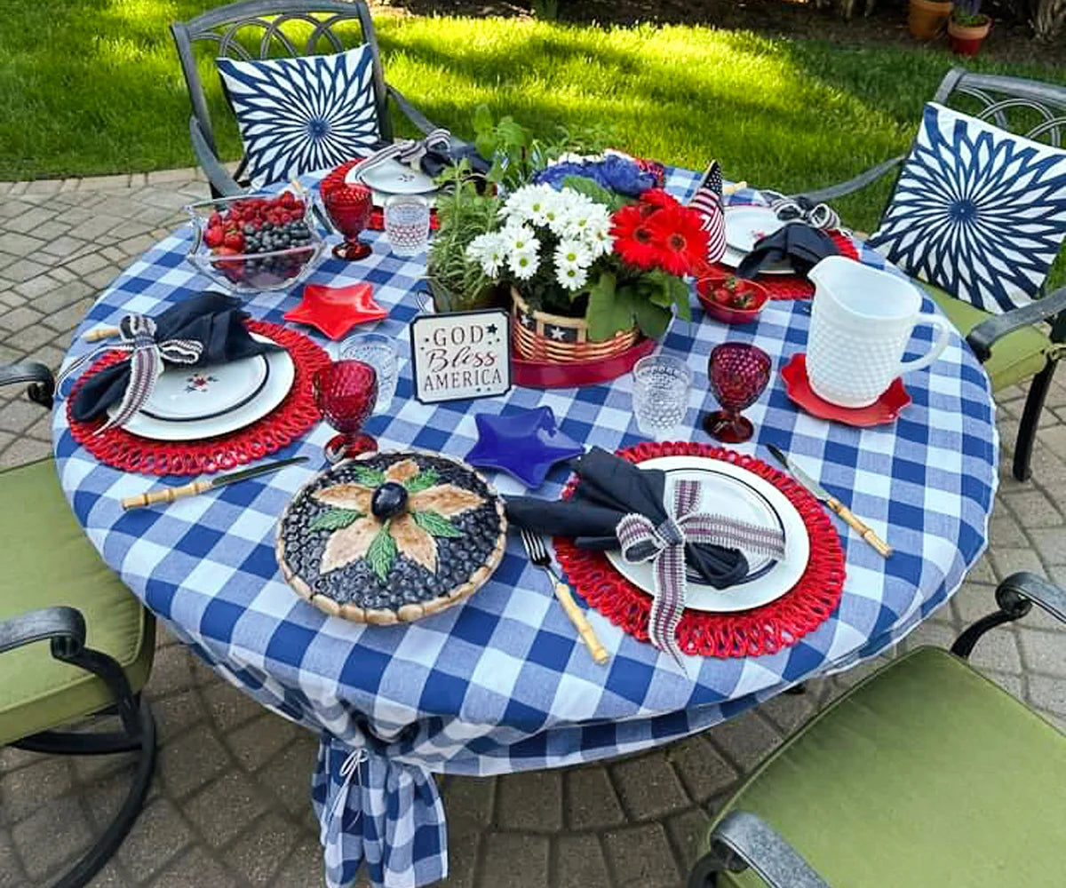 Dark blue and white Buffalo check tablecloth with floral centerpieces in garden Dark blue and white Buffalo check tablecloth with floral centerpieces in garden