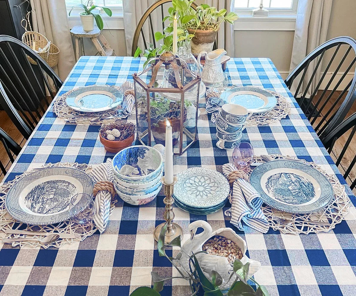 Outdoor table with dark blue and white gingham tablecloth and flowers Outdoor table with dark blue and white gingham tablecloth and flowers
