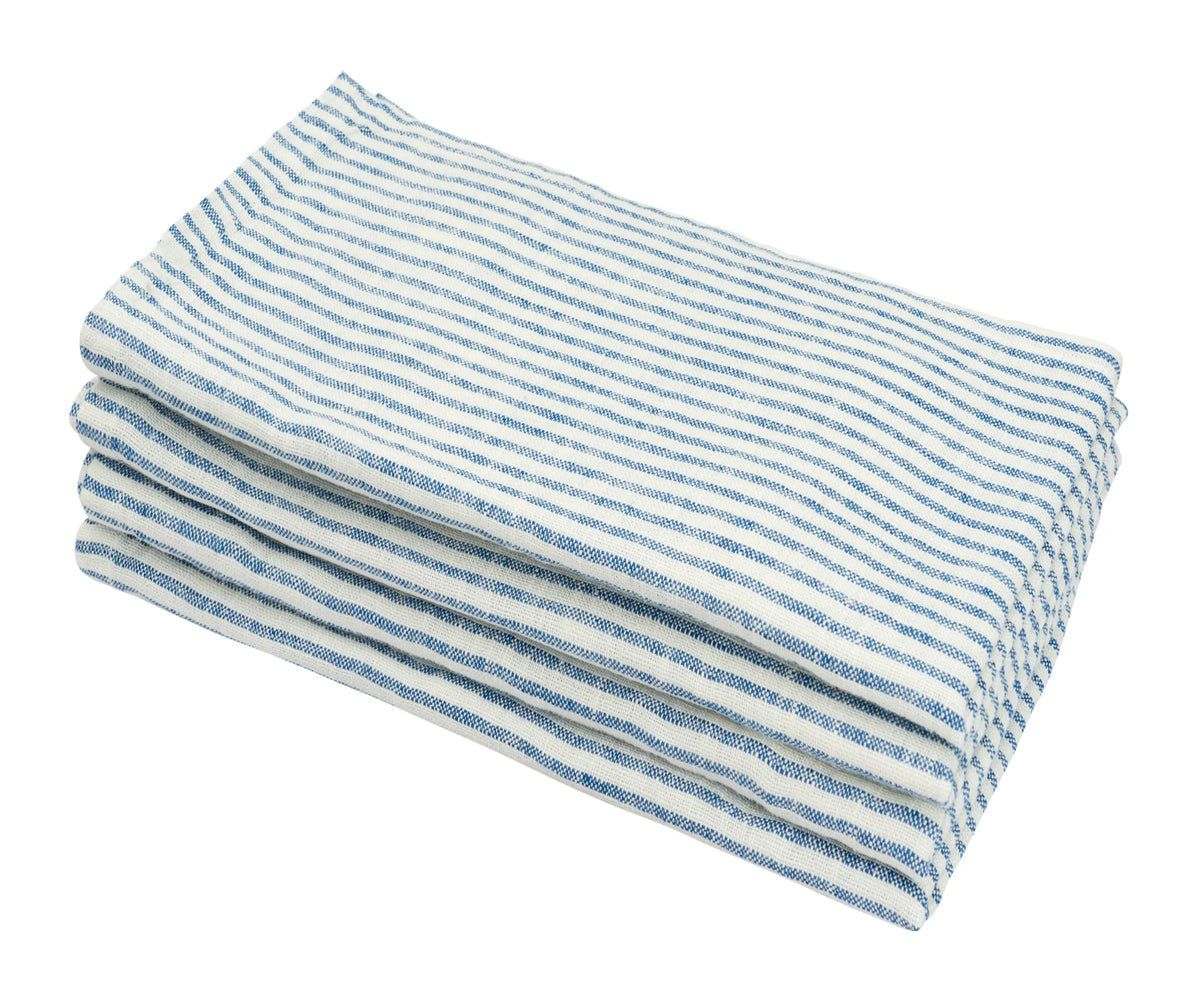 Close-up of a blue linen napkin showcasing the soft texture and clean striped pattern Close-up of a blue linen napkin showcasing the soft texture and clean striped pattern