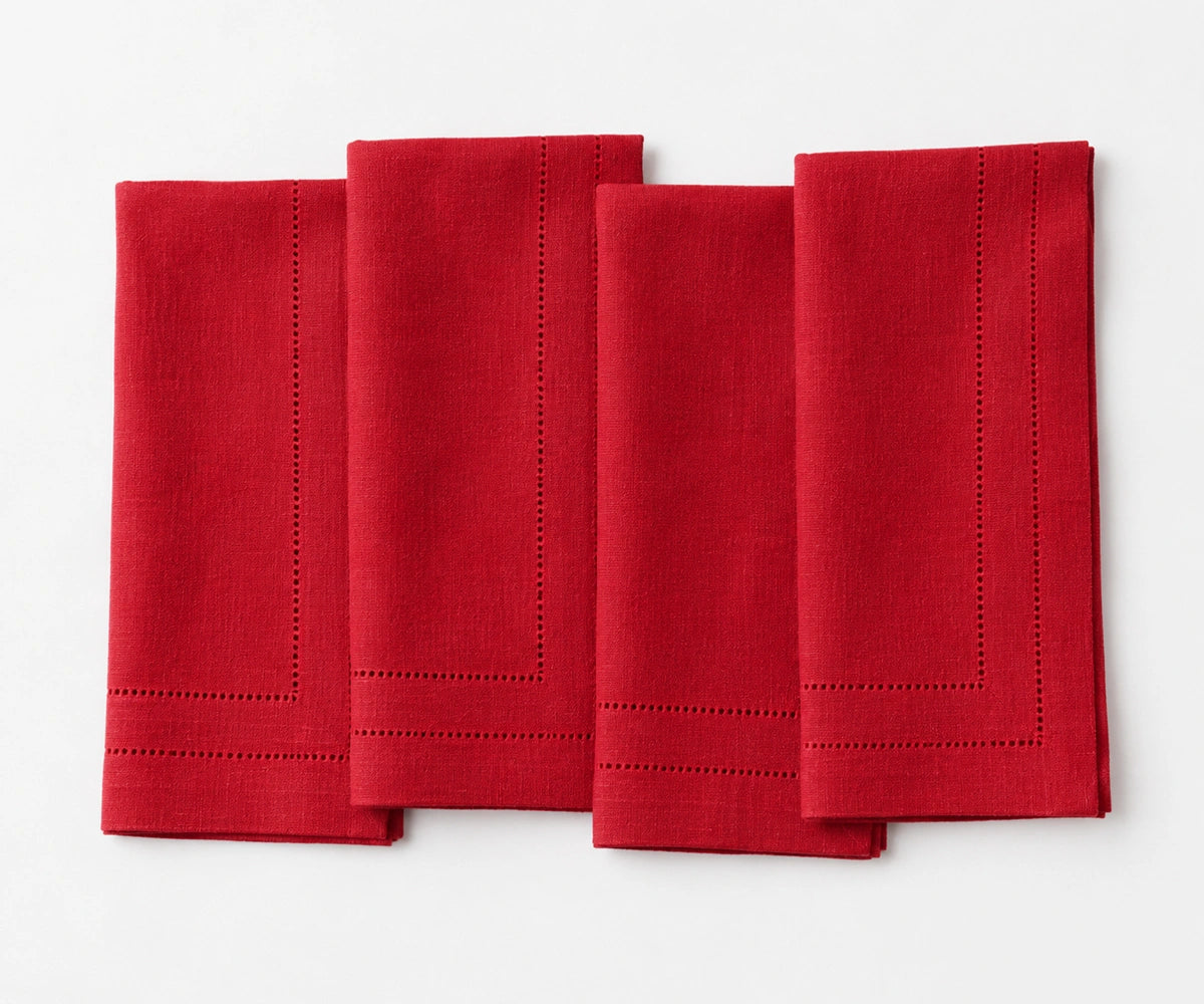 Elegant red linen dinner napkins with double hemstitch trim, designed for Christmas celebrations, holiday entertaining, wedding receptions, and festive dining. Elegant red linen dinner napkins with double hemstitch trim, designed for Christmas celebrations, holiday entertaining, wedding receptions, and festive dining.