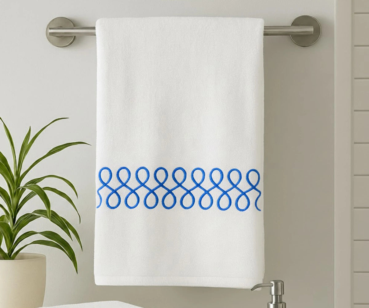 White embroidered bath towel with blue border, soft cotton bath towel, luxury absorbent bathroom towel for everyday use White embroidered bath towel with blue border, soft cotton bath towel, luxury absorbent bathroom towel for everyday use