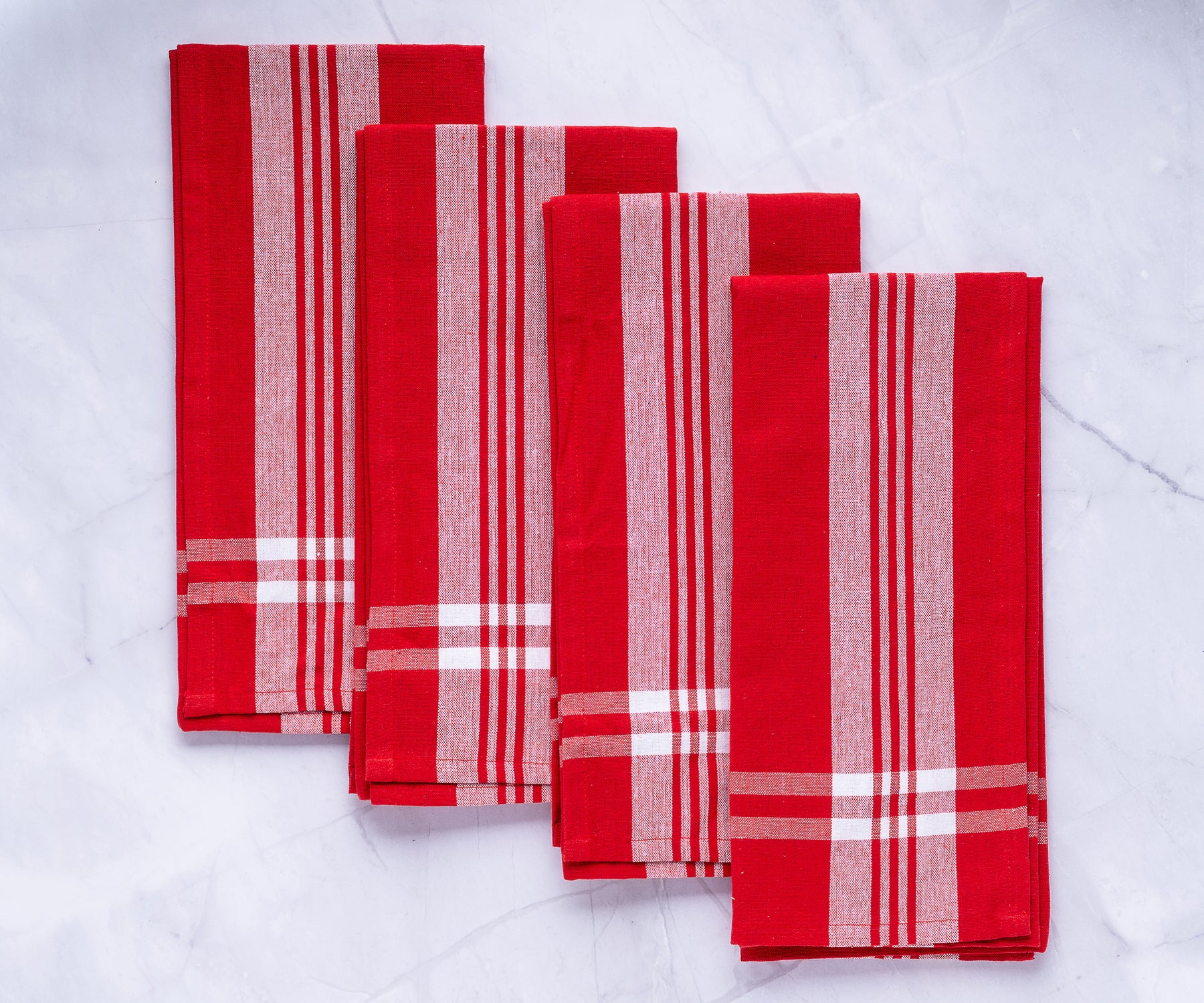 Quartet of red farmhouse kitchen towels featuring white stripe accents Quartet of red farmhouse kitchen towels featuring white stripe accents