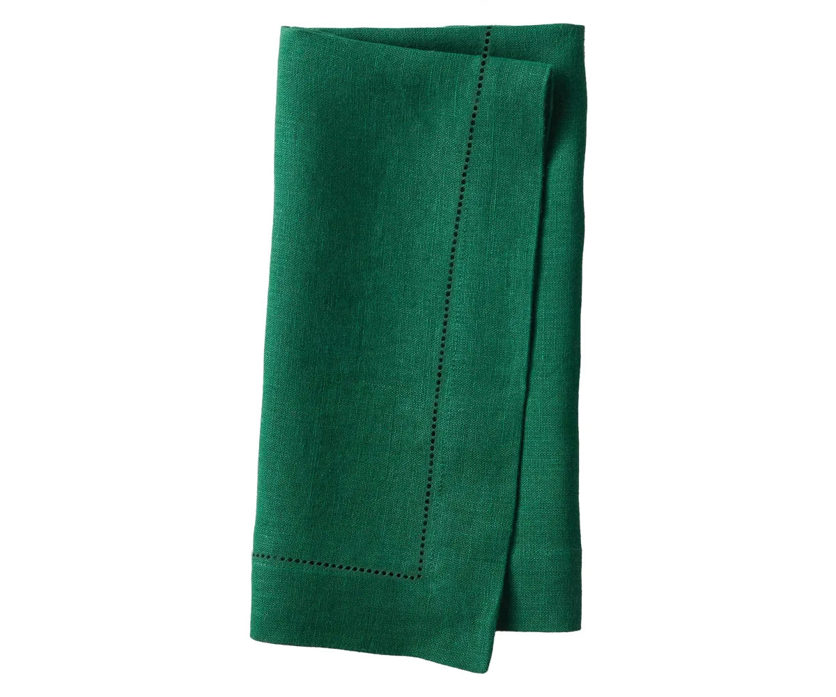 Linen napkins on a formal dining table, styled for a wedding or celebration. Linen napkins on a formal dining table, styled for a wedding or celebration.