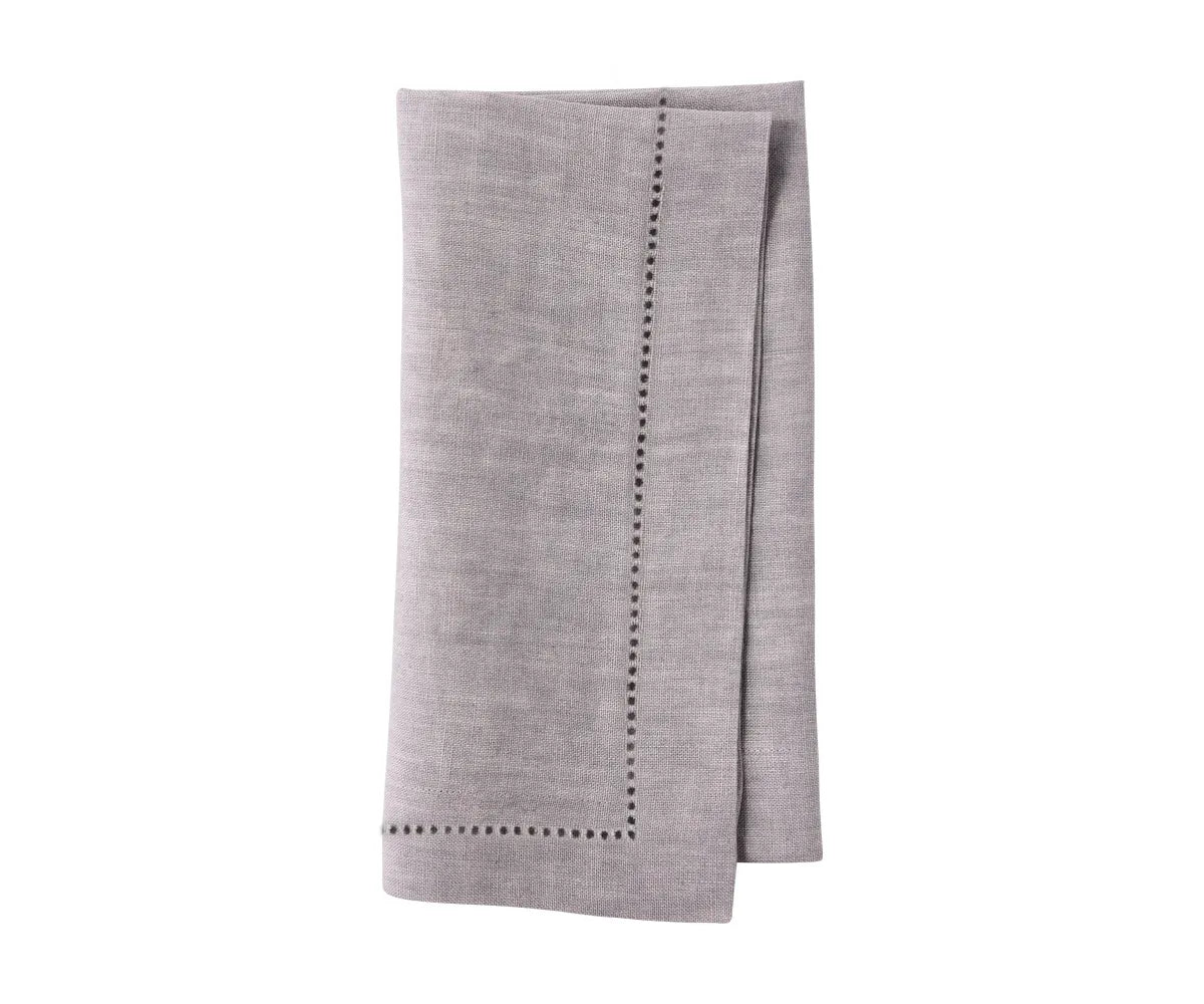 Reusable linen napkins folded elegantly for an eco-conscious table setup.
 Reusable linen napkins folded elegantly for an eco-conscious table setup.