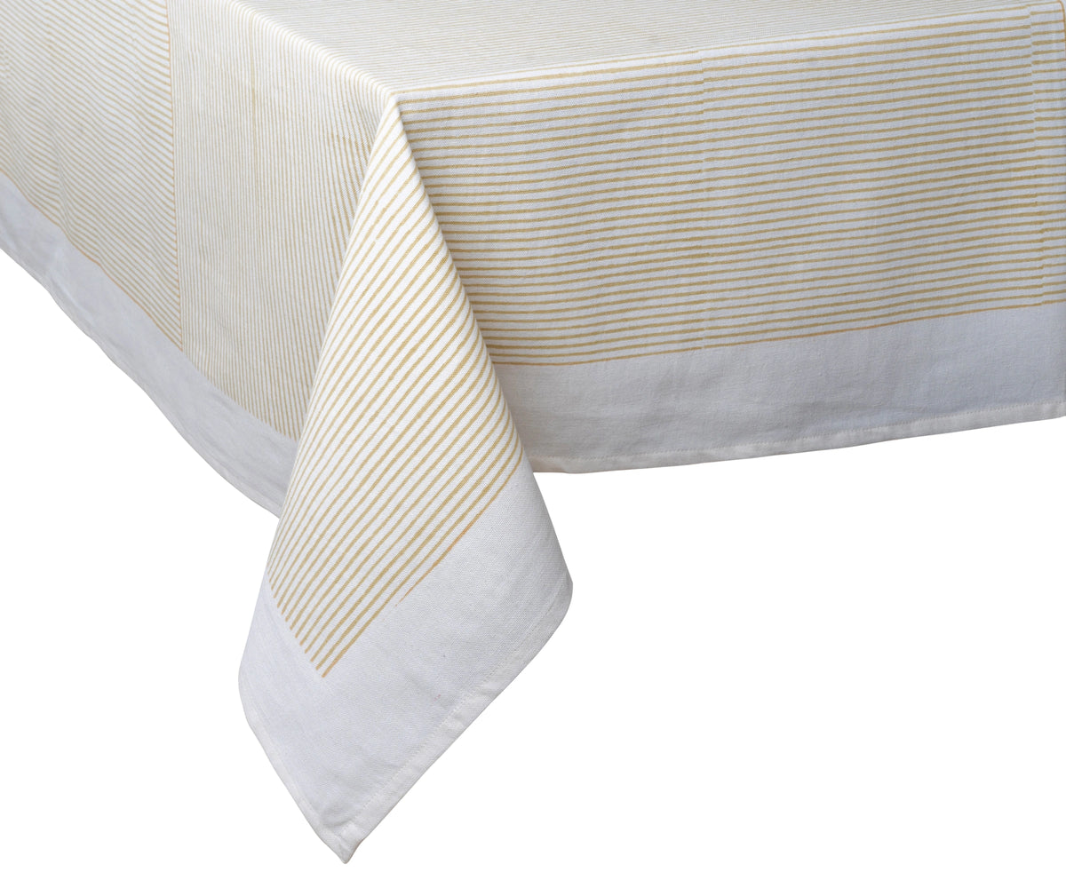 Machine-washable beige cotton tablecloth used in a formal dining setting Machine-washable beige cotton tablecloth used in a formal dining setting