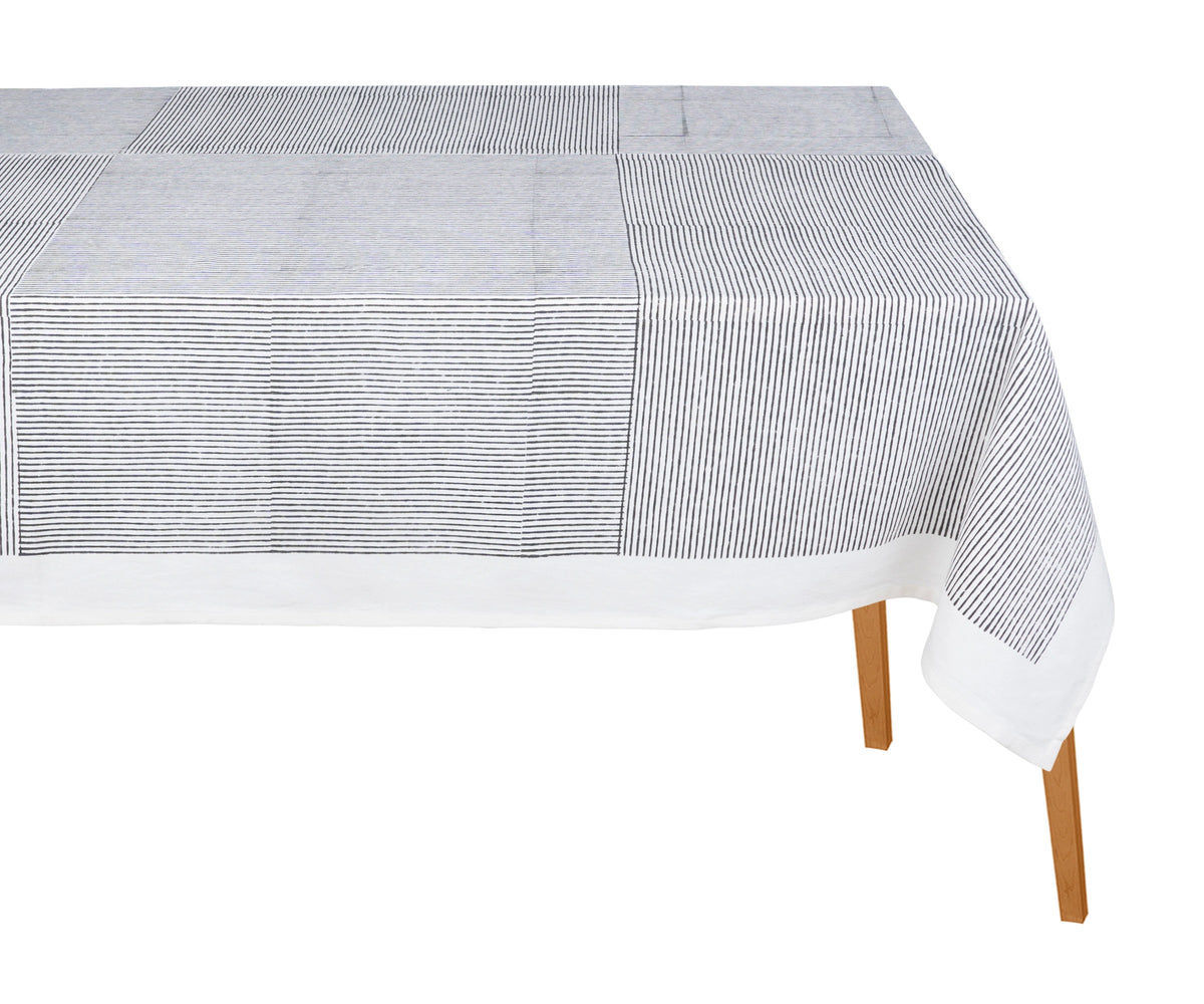 Black cotton rectangular tablecloth with traditional block print design on a dining table Black cotton rectangular tablecloth with traditional block print design on a dining table