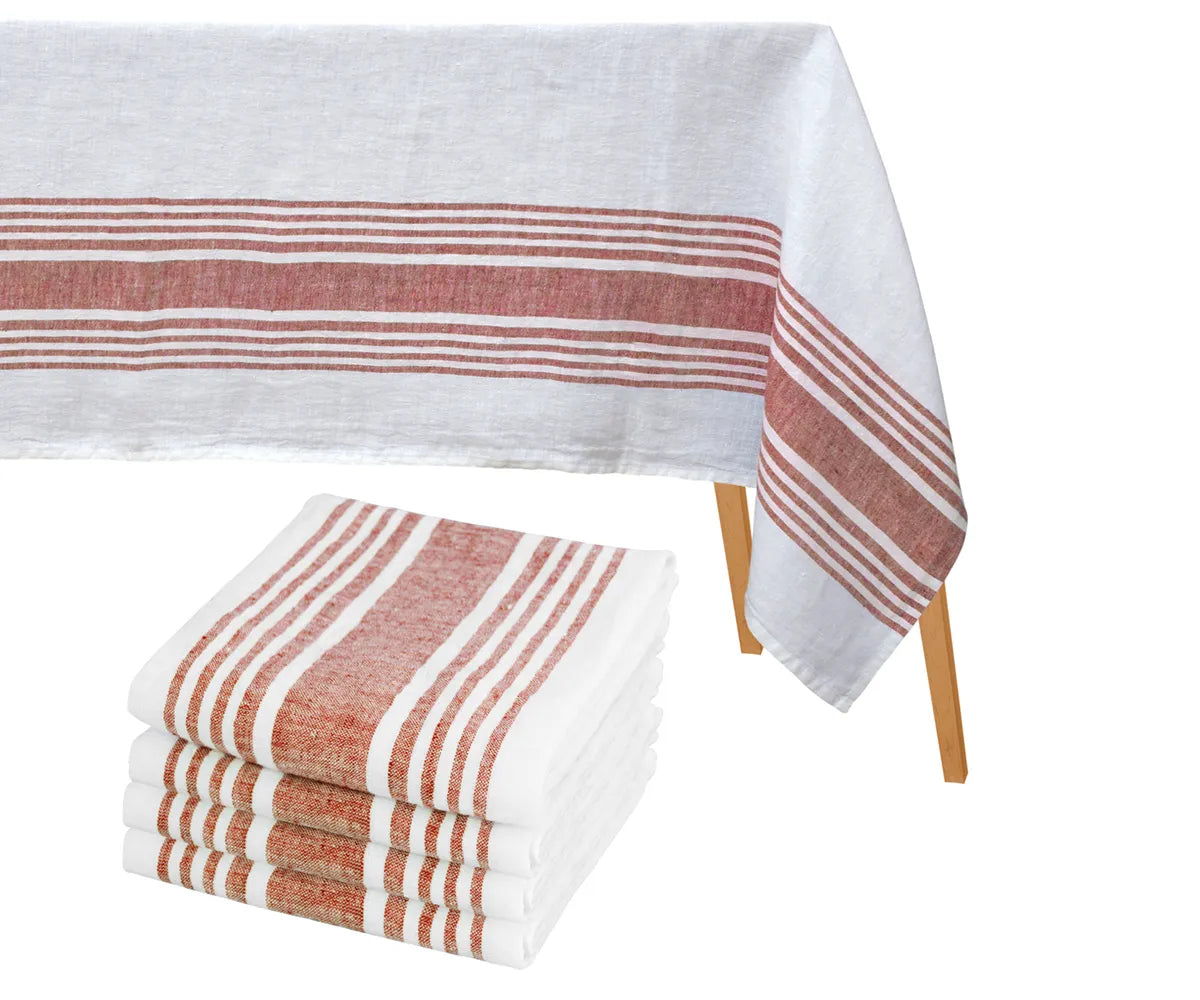 Elegant dining table decorated with a striped cotton tablecloth and matching napkins set Elegant dining table decorated with a striped cotton tablecloth and matching napkins set