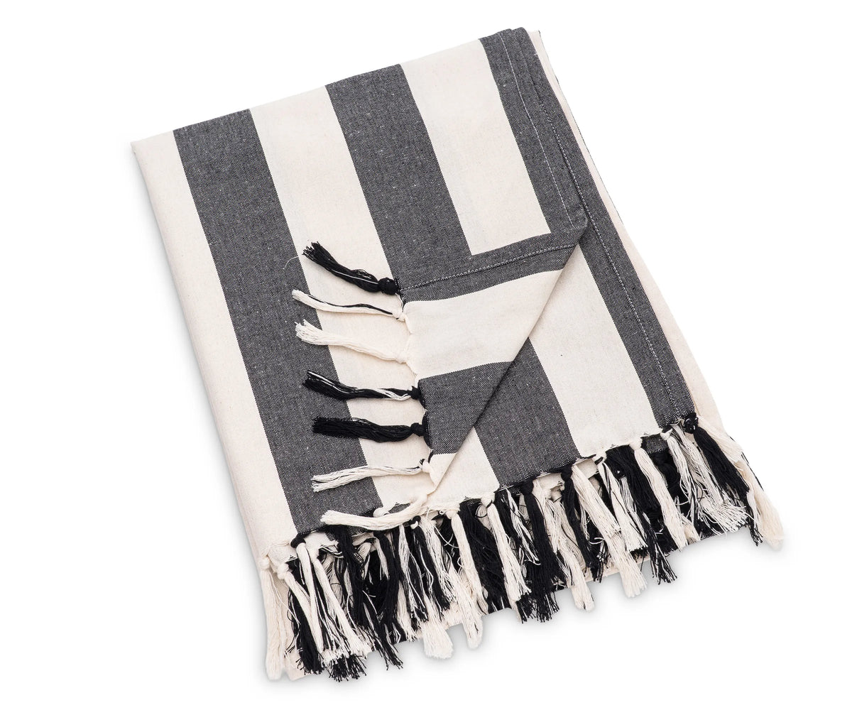 Soft and breathable cotton throw with bold black stripes, styled on a bed as a decorative accent Soft and breathable cotton throw with bold black stripes, styled on a bed as a decorative accent