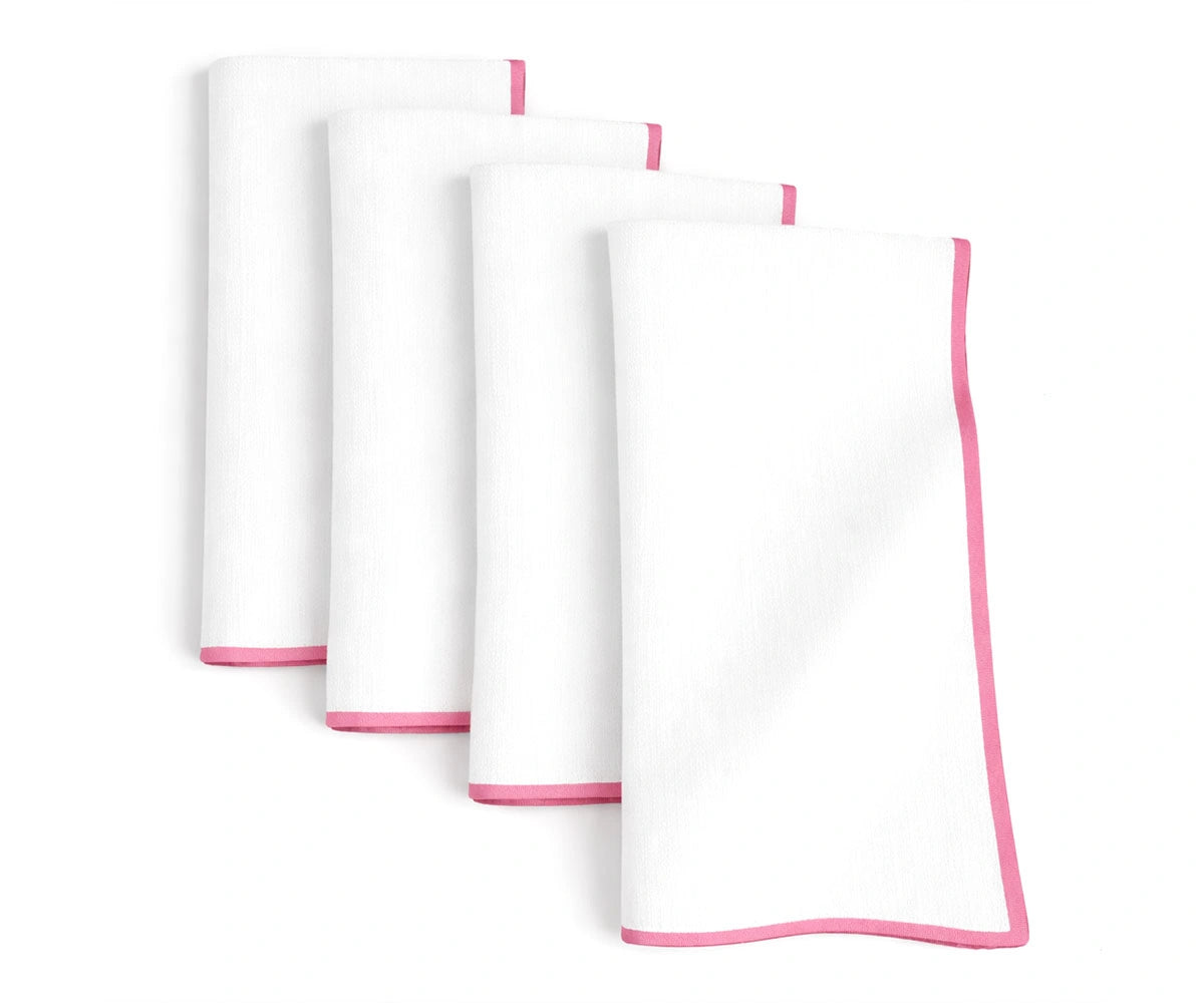 Elegant white cotton napkins highlighted with peony pink merrow stitching Elegant white cotton napkins highlighted with peony pink merrow stitching