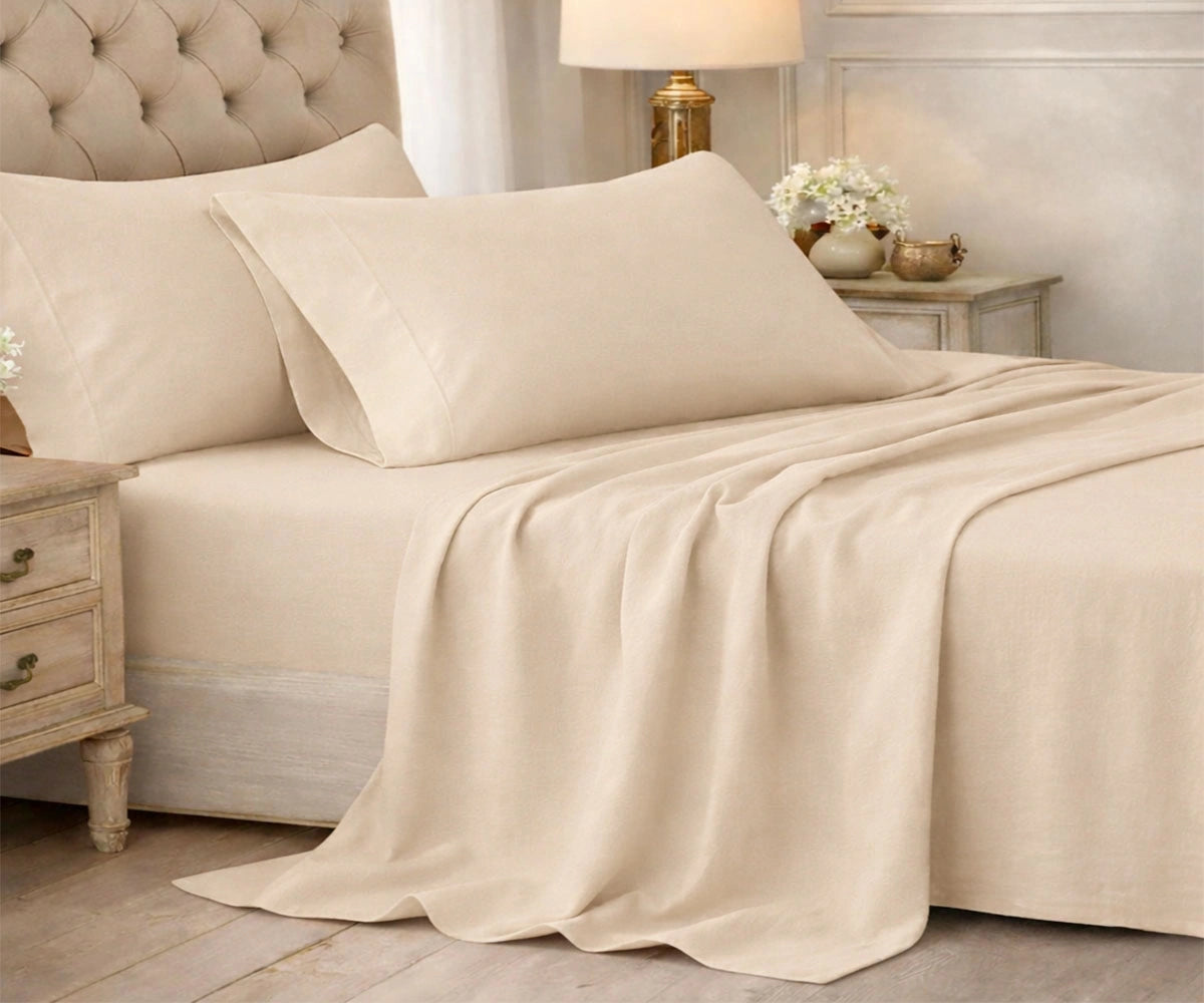 Beige cotton bedsheet set styled on a neutral bedroom bed Beige cotton bedsheet set styled on a neutral bedroom bed