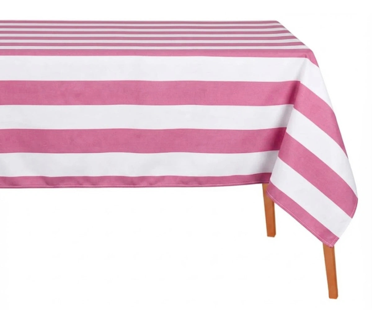 Pink and white wide cabana striped cotton linen tablecloth with straight edges draped over a dining table. Pink and white wide cabana striped cotton linen tablecloth with straight edges draped over a dining table.