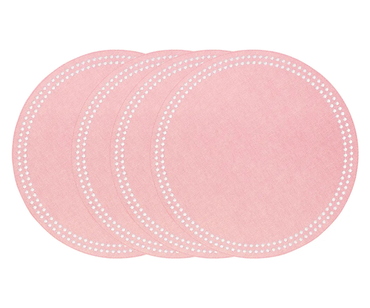 Pink round cotton placemat with embroidered dot trim on a table setup Pink round cotton placemat with embroidered dot trim on a table setup