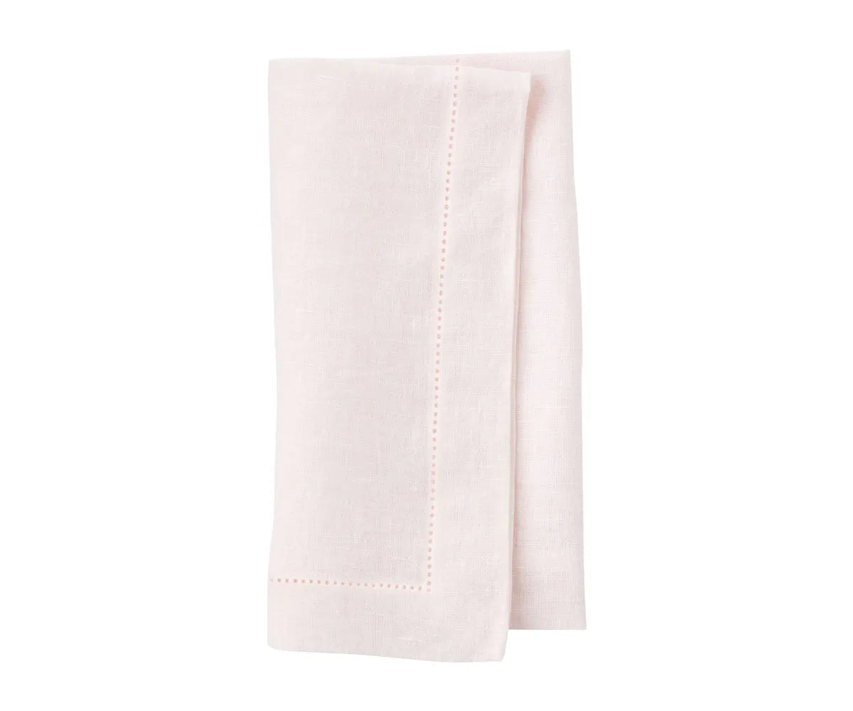 Linen napkins neatly stacked in a basket for buffet-style dining event. Linen napkins neatly stacked in a basket for buffet-style dining event.