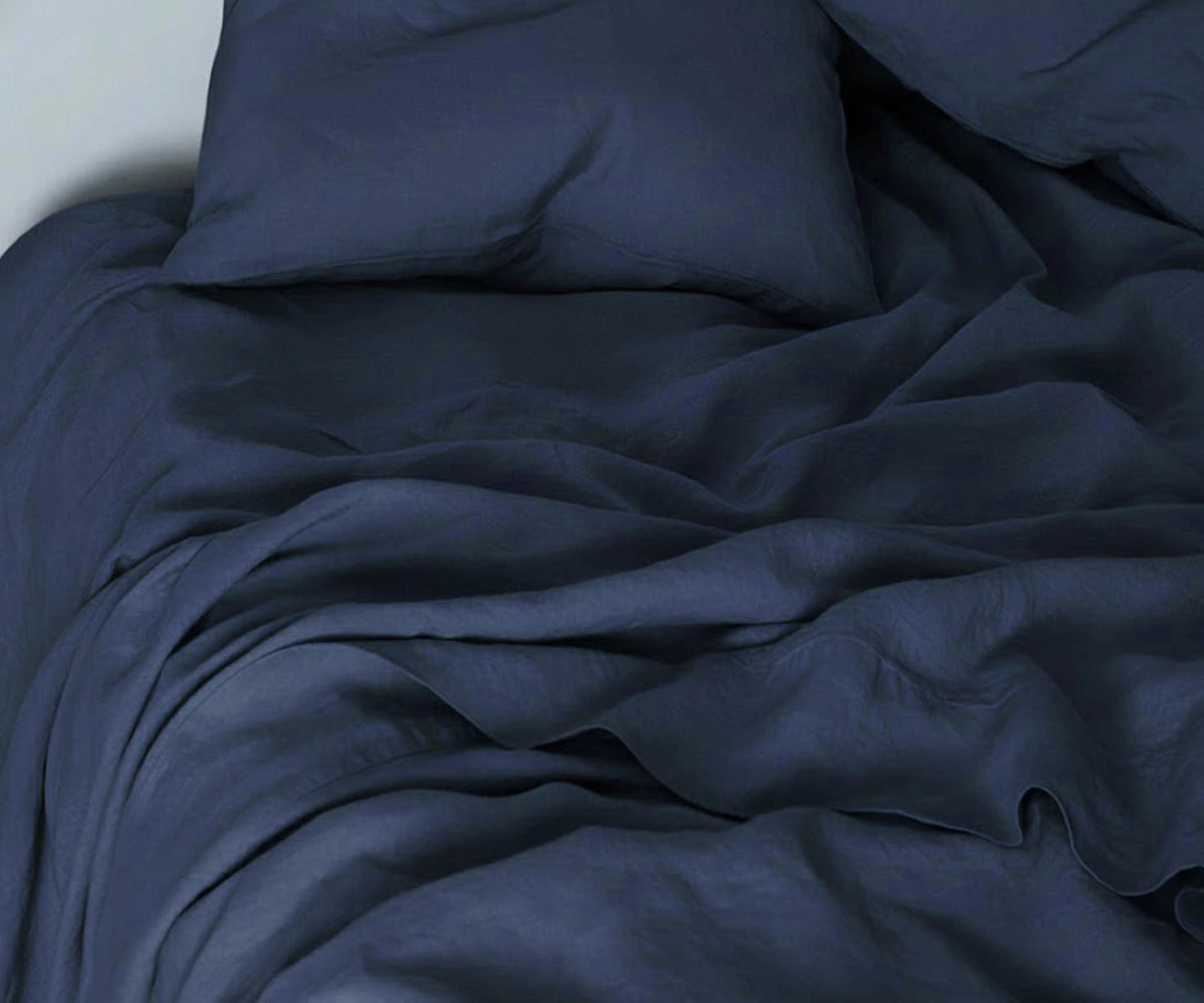 Navy linen bedding set with 100% linen sheets and duvet cover for a stylish contemporary bedroom. Navy linen bedding set with 100% linen sheets and duvet cover for a stylish contemporary bedroom.