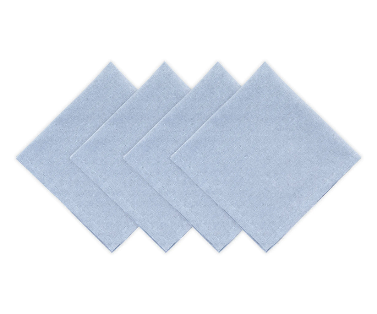 Reusable light blue cotton dinner napkins arranged with white dinnerware Reusable light blue cotton dinner napkins arranged with white dinnerware