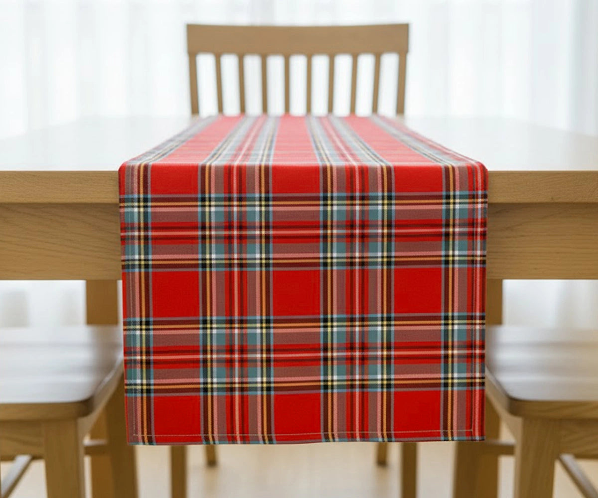 Red tartan plaid cotton table runner with green, navy, and yellow checks adding timeless elegance and festive warmth to a dining table. Red tartan plaid cotton table runner with green, navy, and yellow checks adding timeless elegance and festive warmth to a dining table.