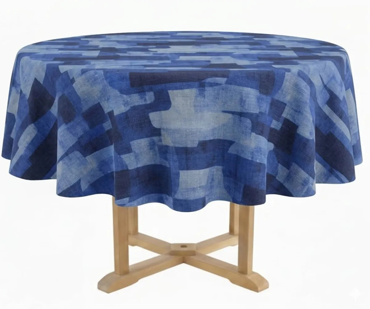 Modern patterned round tablecloth draped over a wooden pedestal table, showcasing a textured fabric surface and flowing edges. Modern patterned round tablecloth draped over a wooden pedestal table, showcasing a textured fabric surface and flowing edges.