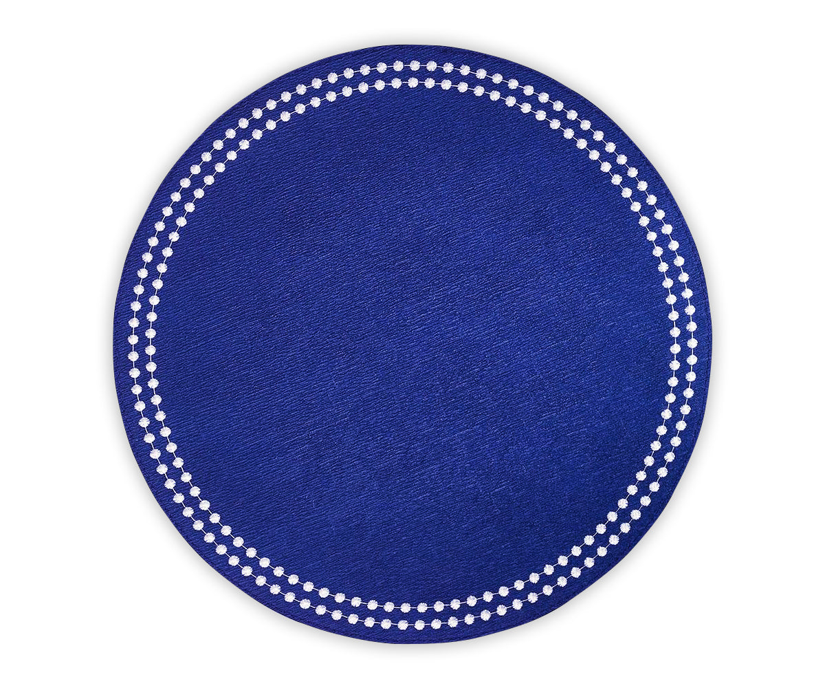 Set of 4 embroidered blue and white cotton placemats styled for a table setting Set of 4 embroidered blue and white cotton placemats styled for a table setting
