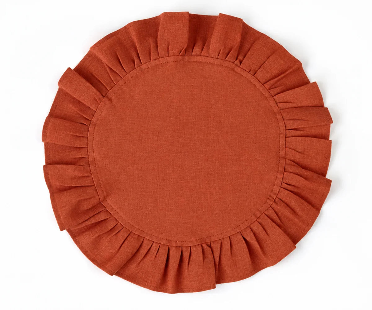 Rust round cotton napkins with decorative ruffled edges, adding warmth and character to neutral tableware. Rust round cotton napkins with decorative ruffled edges, adding warmth and character to neutral tableware.