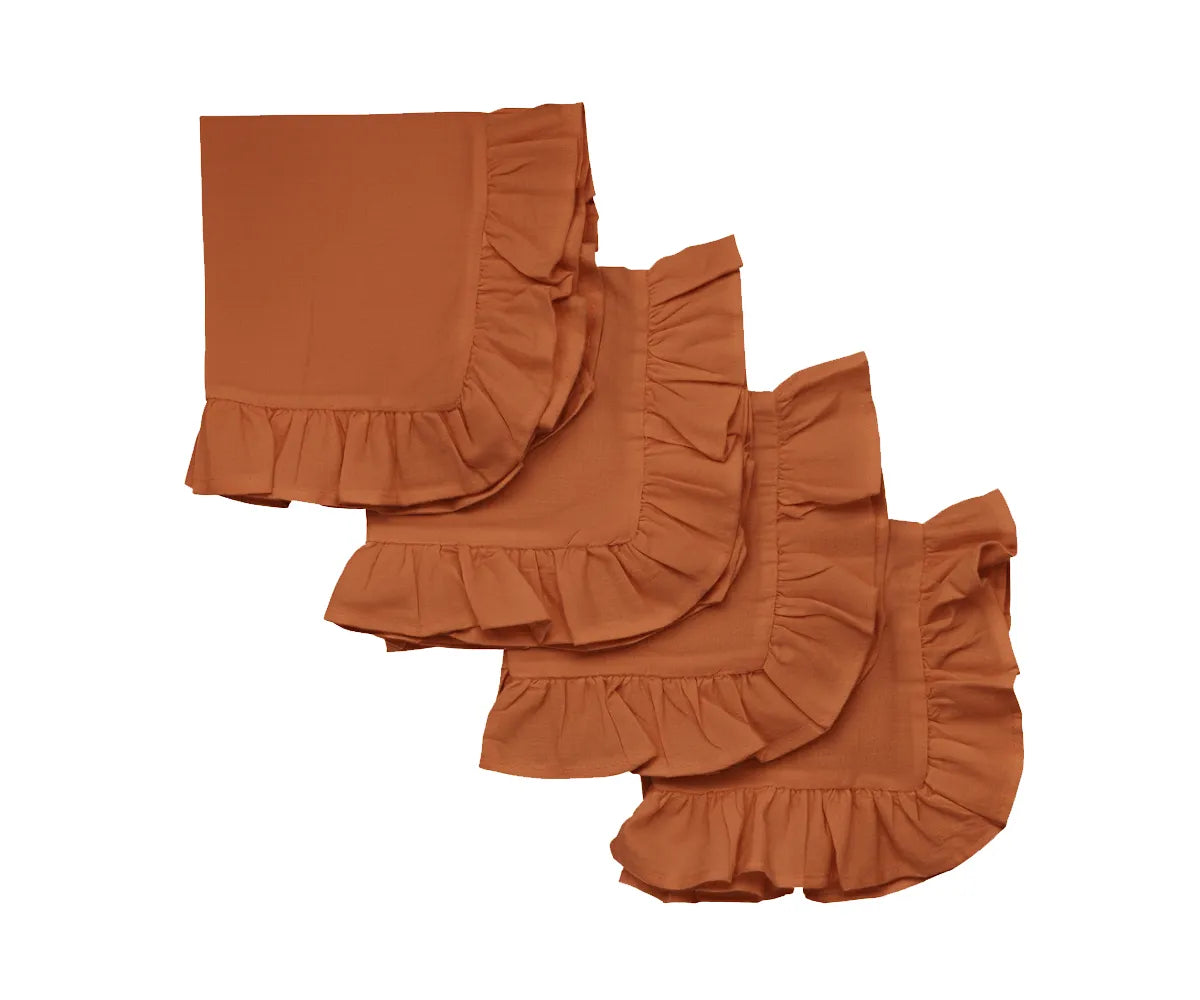 Rust ruffle edge cotton cloth napkins set on a dining table Rust ruffle edge cotton cloth napkins set on a dining table