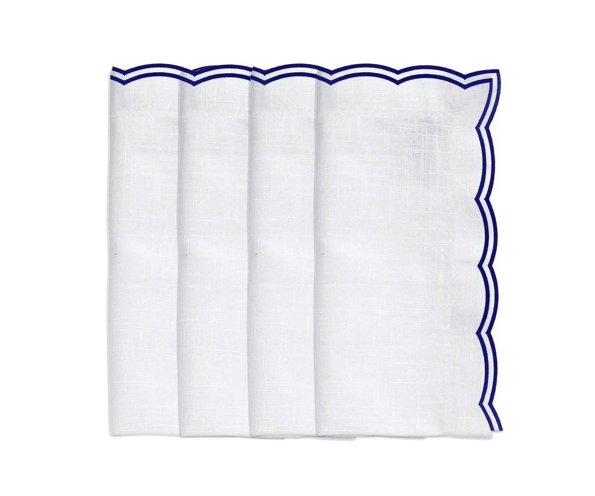 Navy scalloped napkins on a rustic wood table setup for casual dinners Navy scalloped napkins on a rustic wood table setup for casual dinners