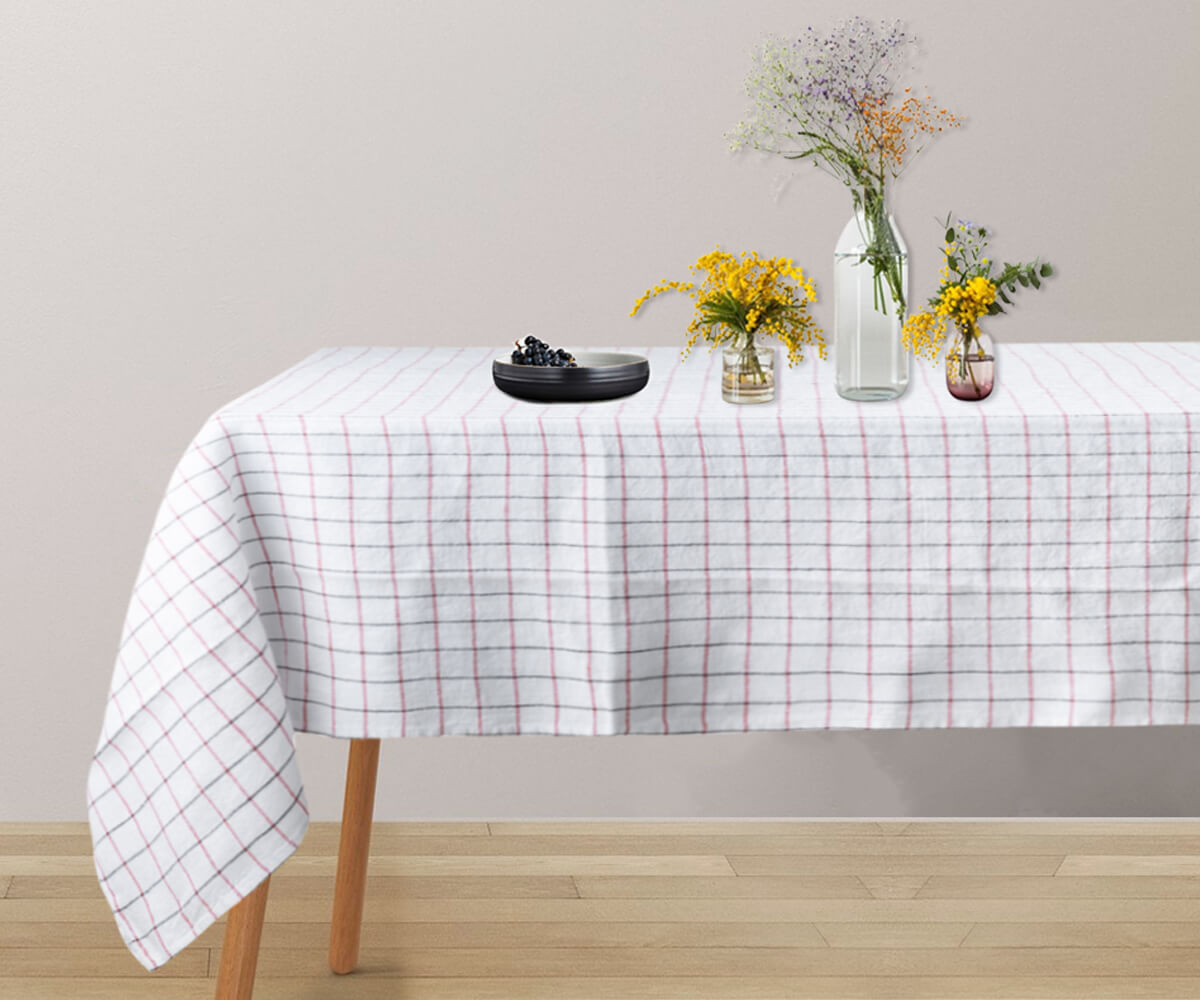 A round linen tablecloth in a calming white hue. A round linen tablecloth in a calming white hue.