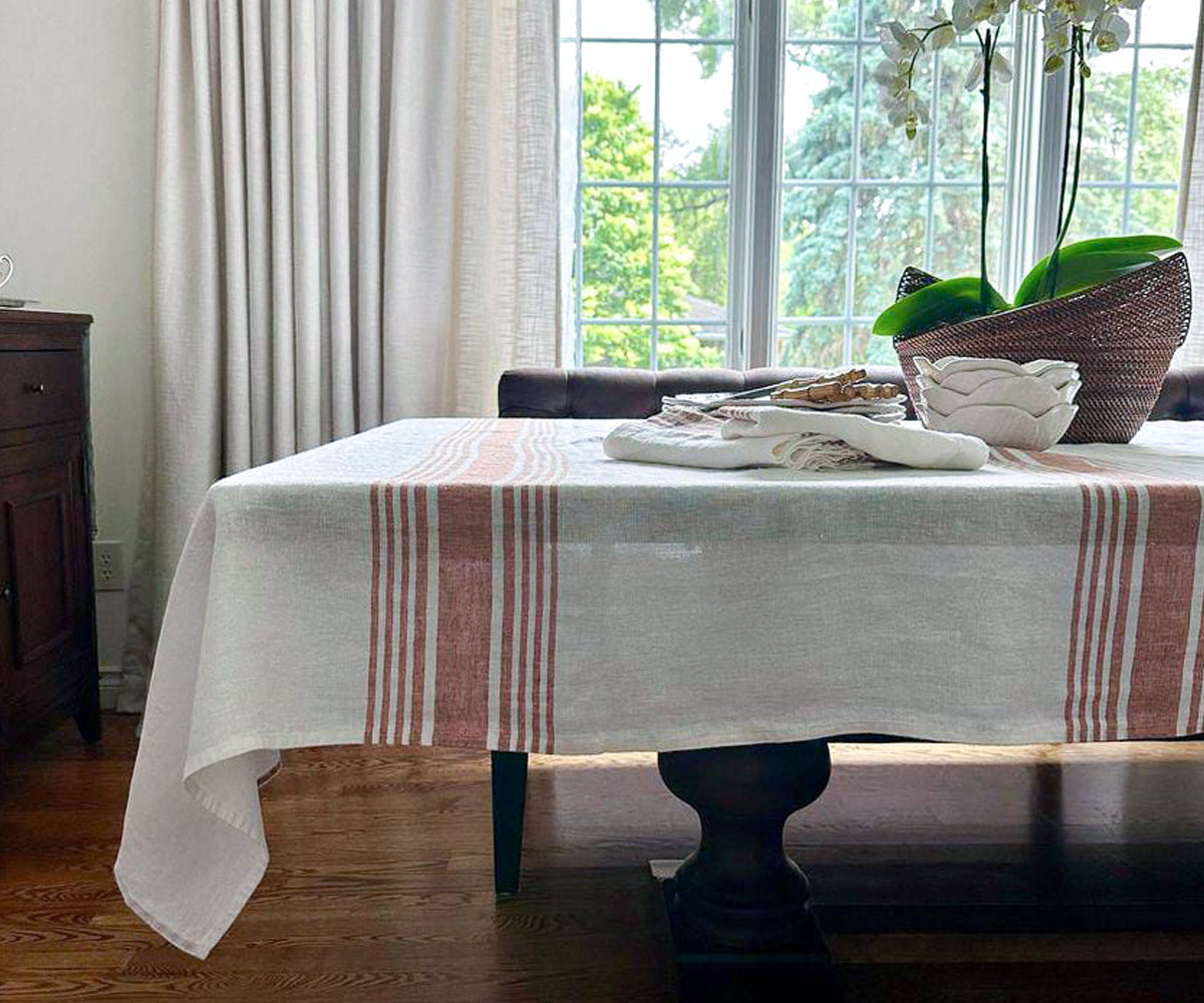 White linen tablecloth on a dining room table White linen tablecloth on a dining room table