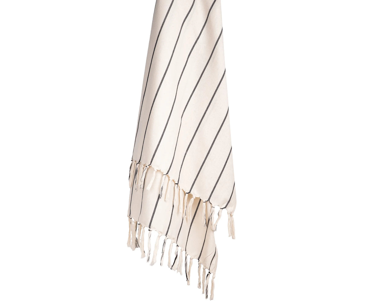 Black and white striped cotton throw blanket styled on a sofa, adding a clean and modern touch Black and white striped cotton throw blanket styled on a sofa, adding a clean and modern touch