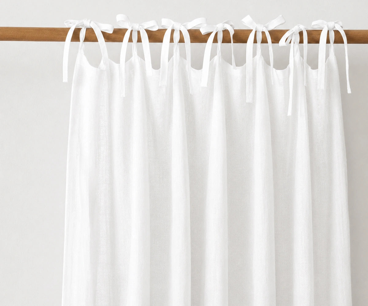 White natural linen tie top curtains, airy light filtering window panels for Scandinavian, coastal, and minimalist home interiors. White natural linen tie top curtains, airy light filtering window panels for Scandinavian, coastal, and minimalist home interiors.