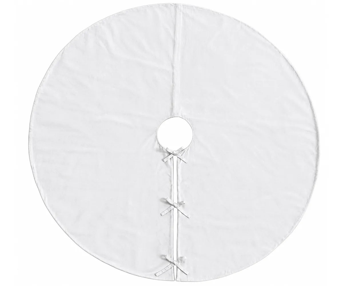 White linen tree skirt adding a simple finished backdrop around the base of a Christmas tree White linen tree skirt adding a simple finished backdrop around the base of a Christmas tree