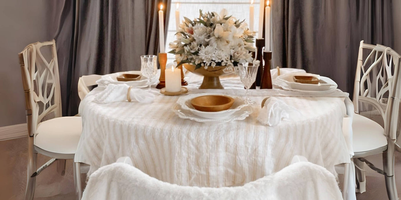 Wedding table with white linens, gold accents, and floral centerpiece. Wedding table with white linens, gold accents, and floral centerpiece.