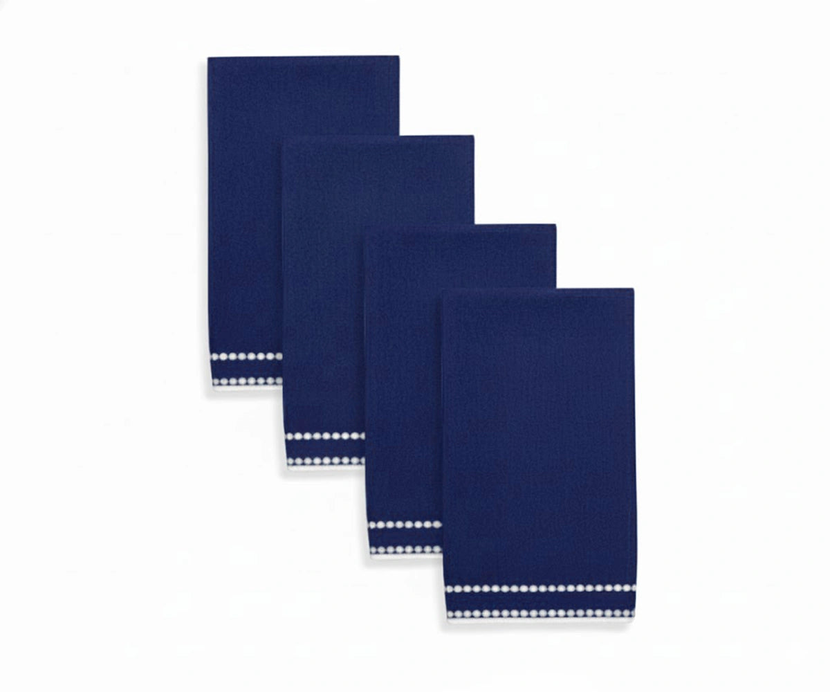 Dark navy, white pearl-dotted napkin featuring intricate pearl stitching for a refined dinner setup. Dark navy, white pearl-dotted napkin featuring intricate pearl stitching for a refined dinner setup.