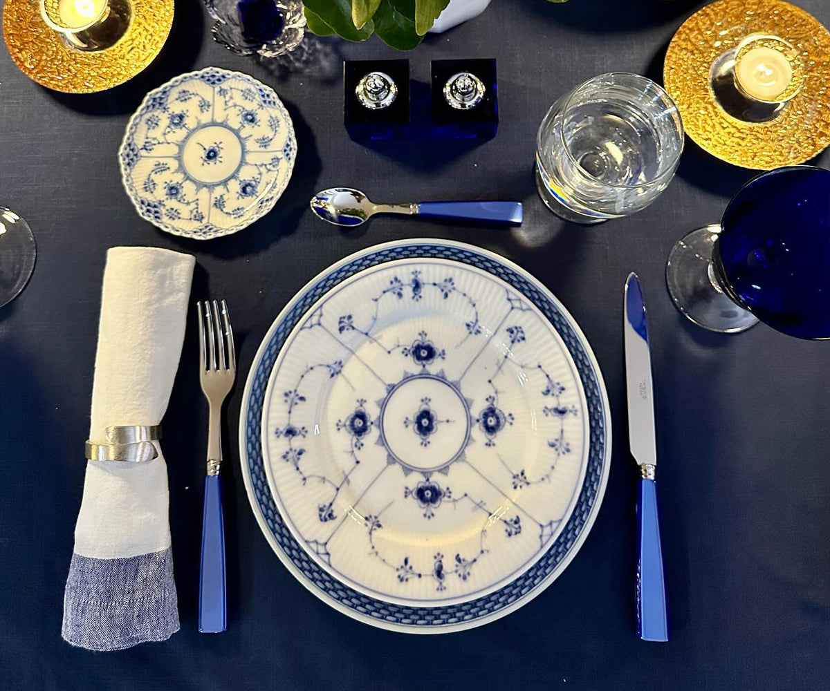 Dinner table with neatly folded linen cloth napkins Dinner table with neatly folded linen cloth napkins