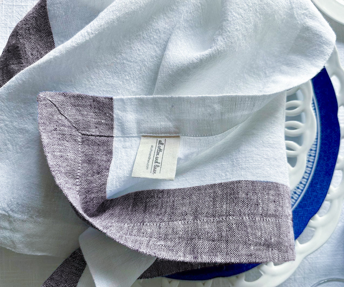 Fancy white linen napkin folded on a dining plate Fancy white linen napkin folded on a dining plate