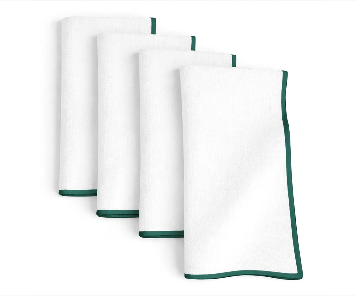 White base cotton napkins detailed with green merrow stitching for casual and festive dining tables White base cotton napkins detailed with green merrow stitching for casual and festive dining tables