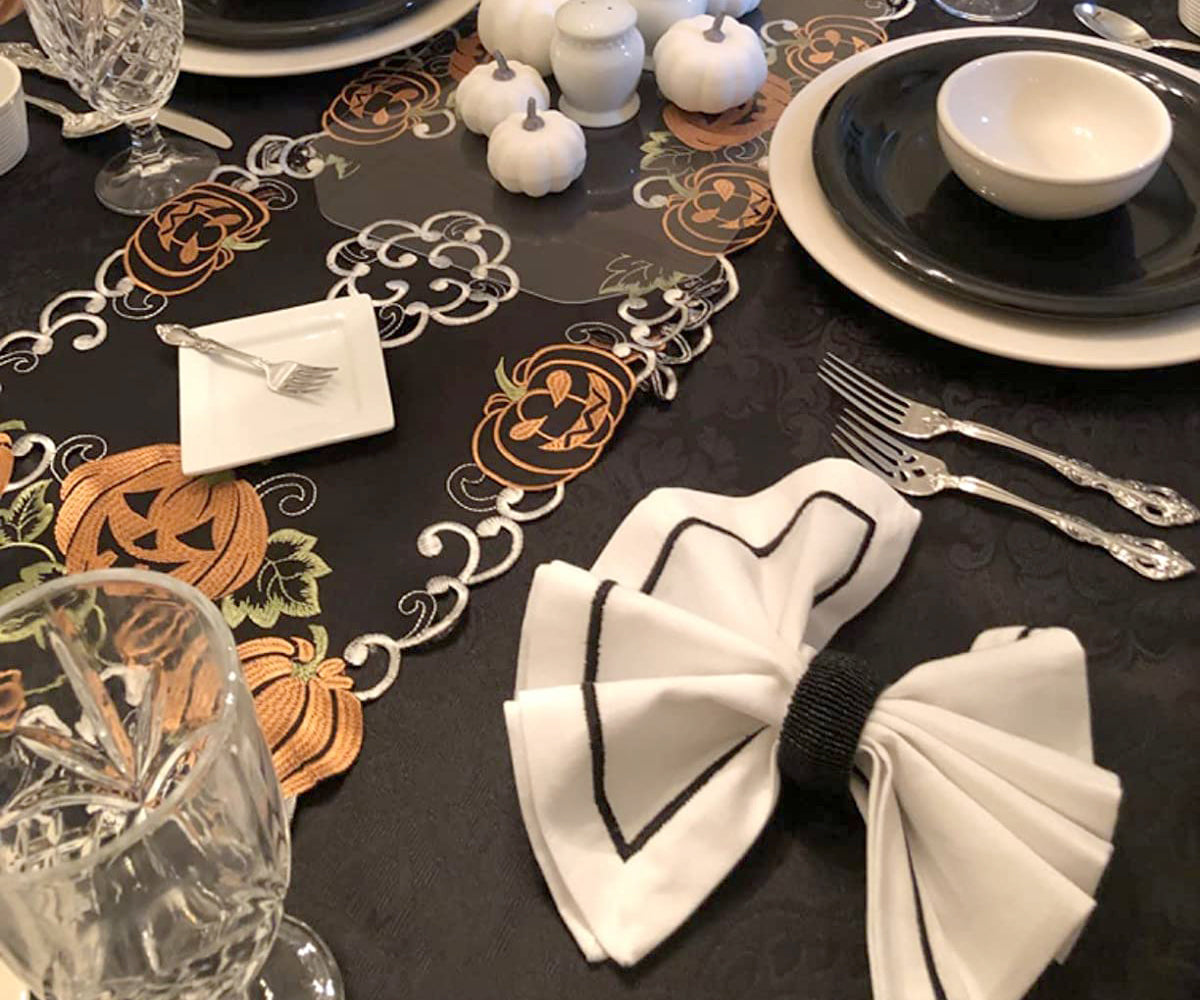 Black dinner napkins complementing a Halloween-themed table decor Black dinner napkins complementing a Halloween-themed table decor