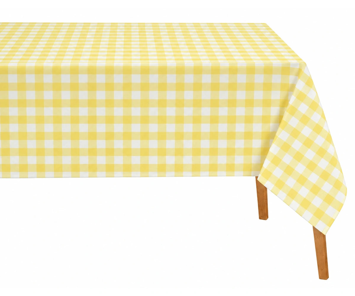 Yellow checked tablecloth styled with white dinnerware and natural woven placemats. Yellow checked tablecloth styled with white dinnerware and natural woven placemats.