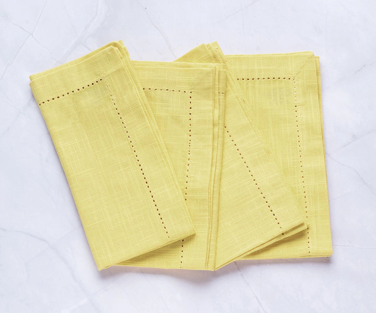 Close-up of hemstitch detailing on butter yellow cloth napkin
 Close-up of hemstitch detailing on butter yellow cloth napkin