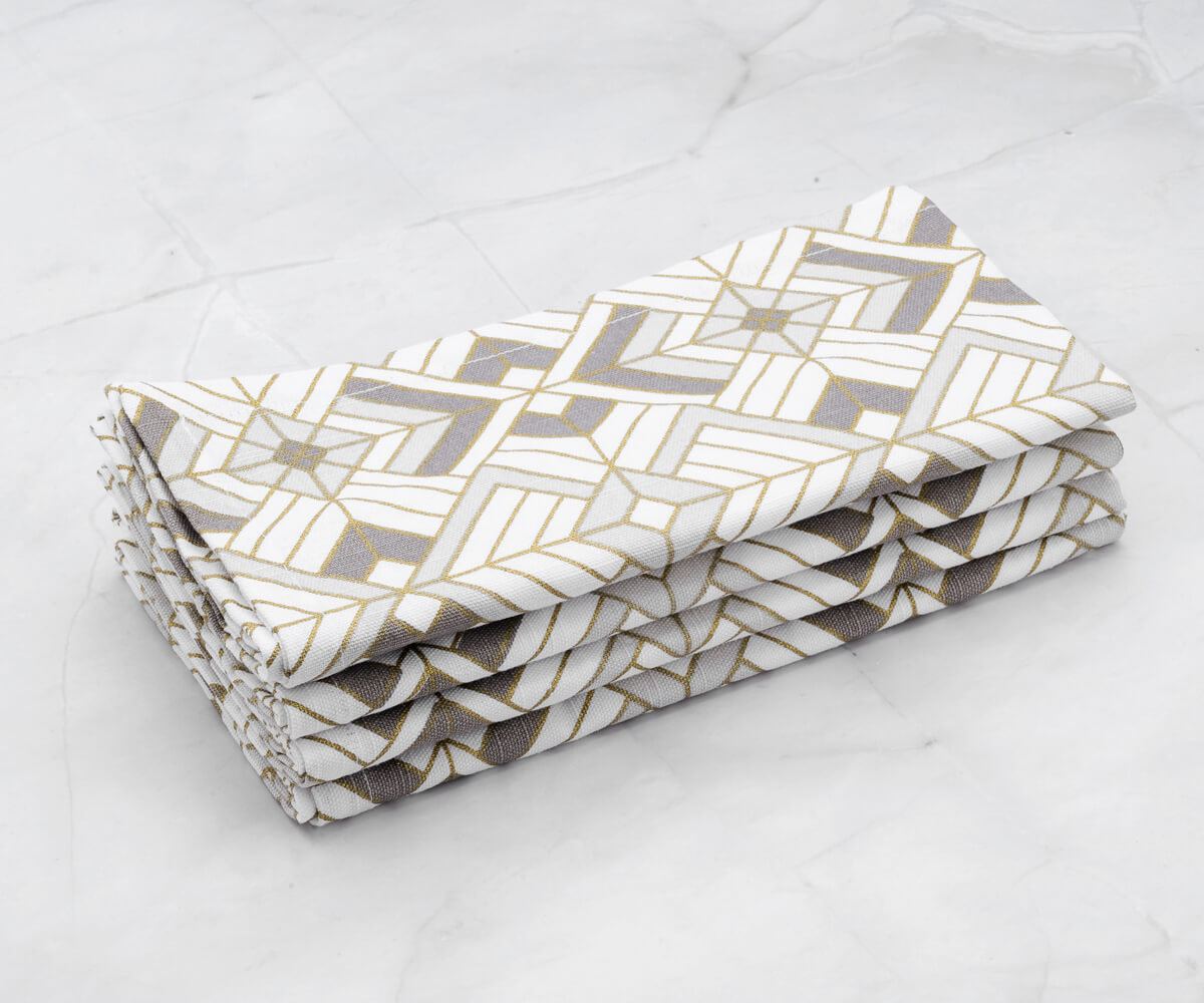 SILVER NAPKINS: Printed napkins which are Set of 4 - gold cocktail napkins with geometric pattern are arranged one above another. SILVER NAPKINS: Printed napkins which are Set of 4 - gold cocktail napkins with geometric pattern are arranged one above another.