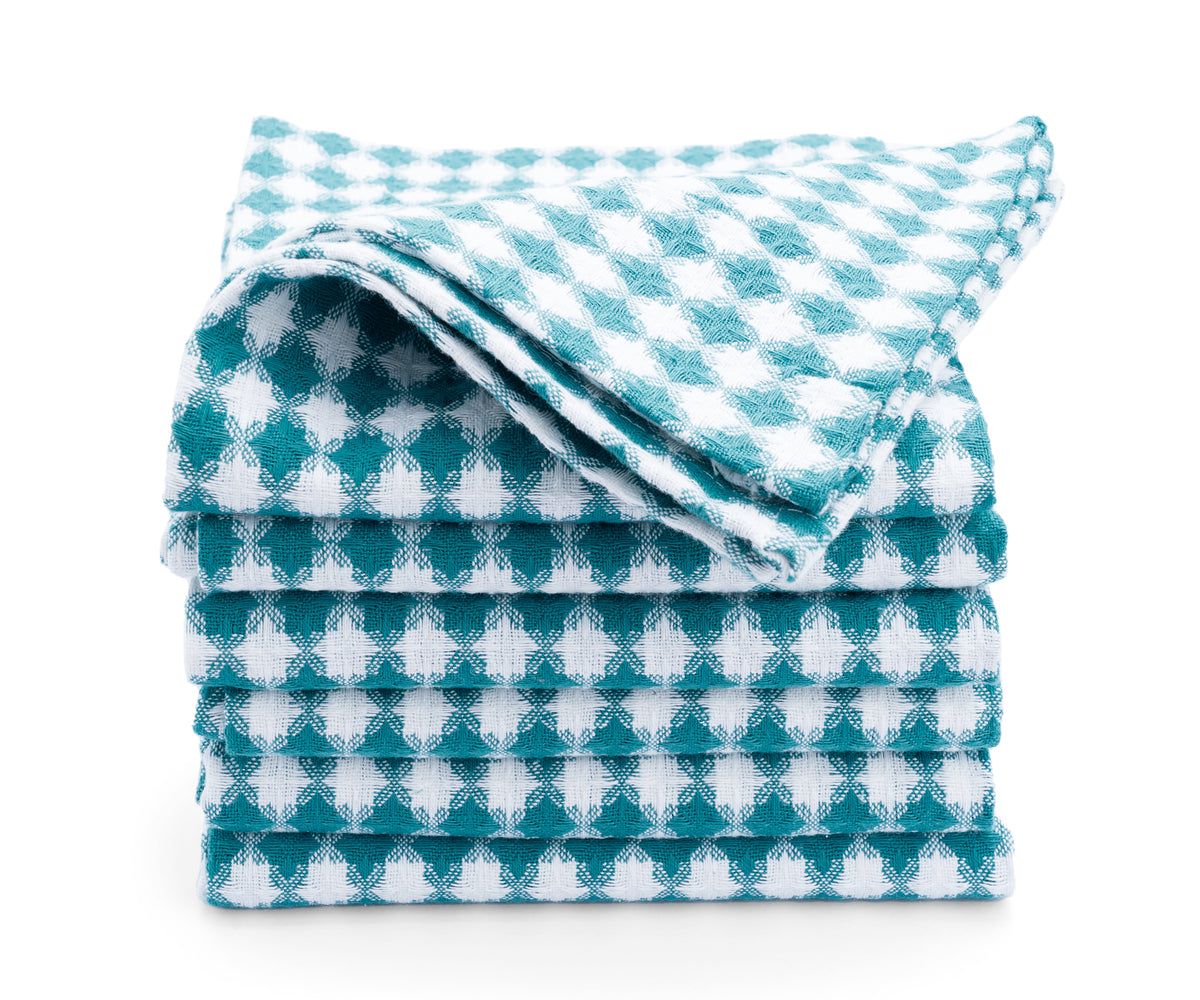 Colorful cotton kitchen towels hanging on a rack, ready to tackle any mess. Colorful cotton kitchen towels hanging on a rack, ready to tackle any mess.