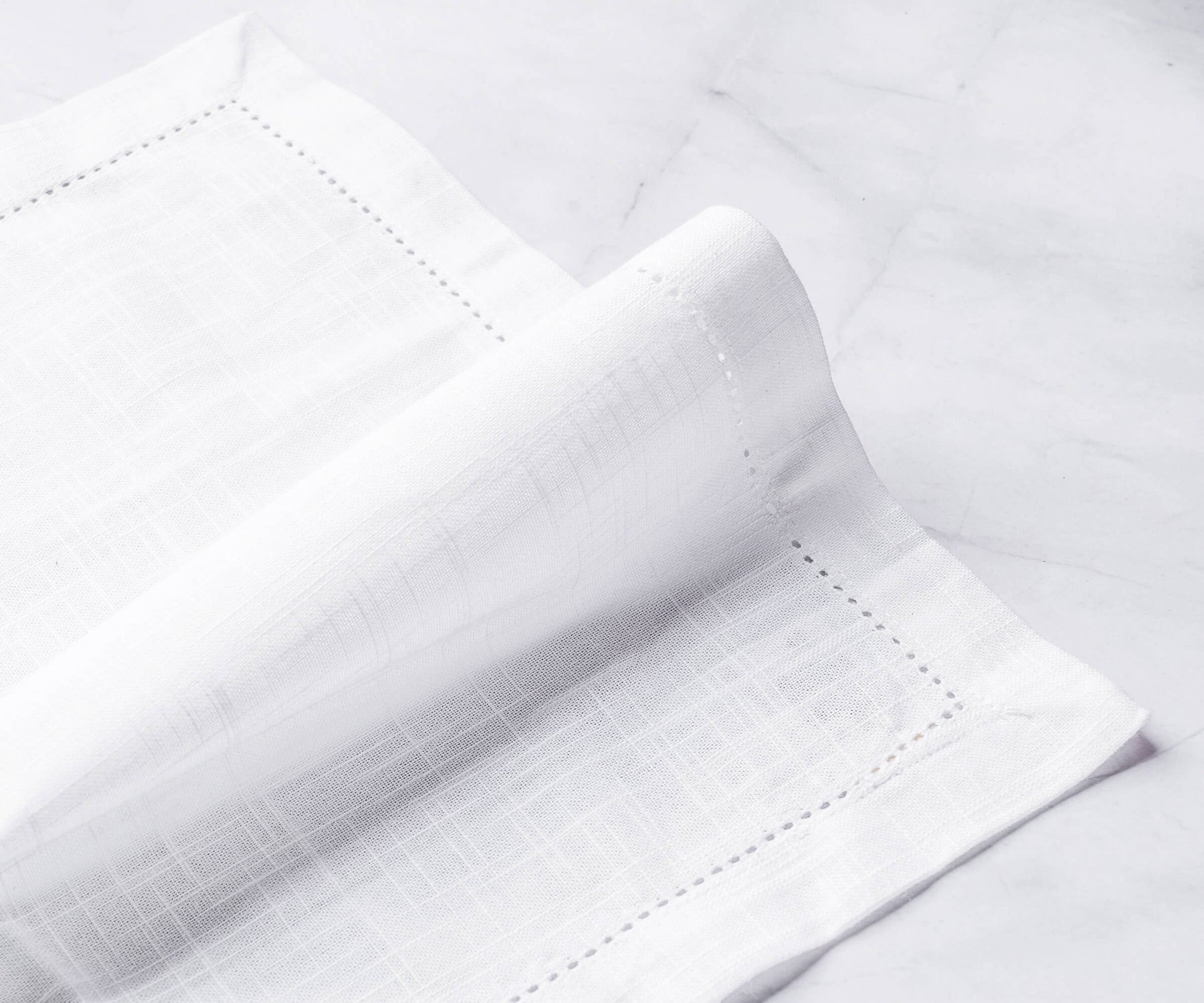 white dinner napkins, cocktail napkins with 1-inch border and small folding on the white floor white dinner napkins, cocktail napkins with 1-inch border and small folding on the white floor