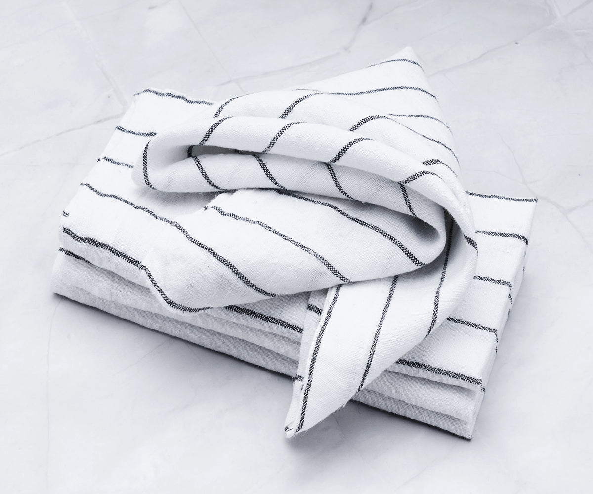 Skillfully folded white table napkins showcasing an intricate folding technique.