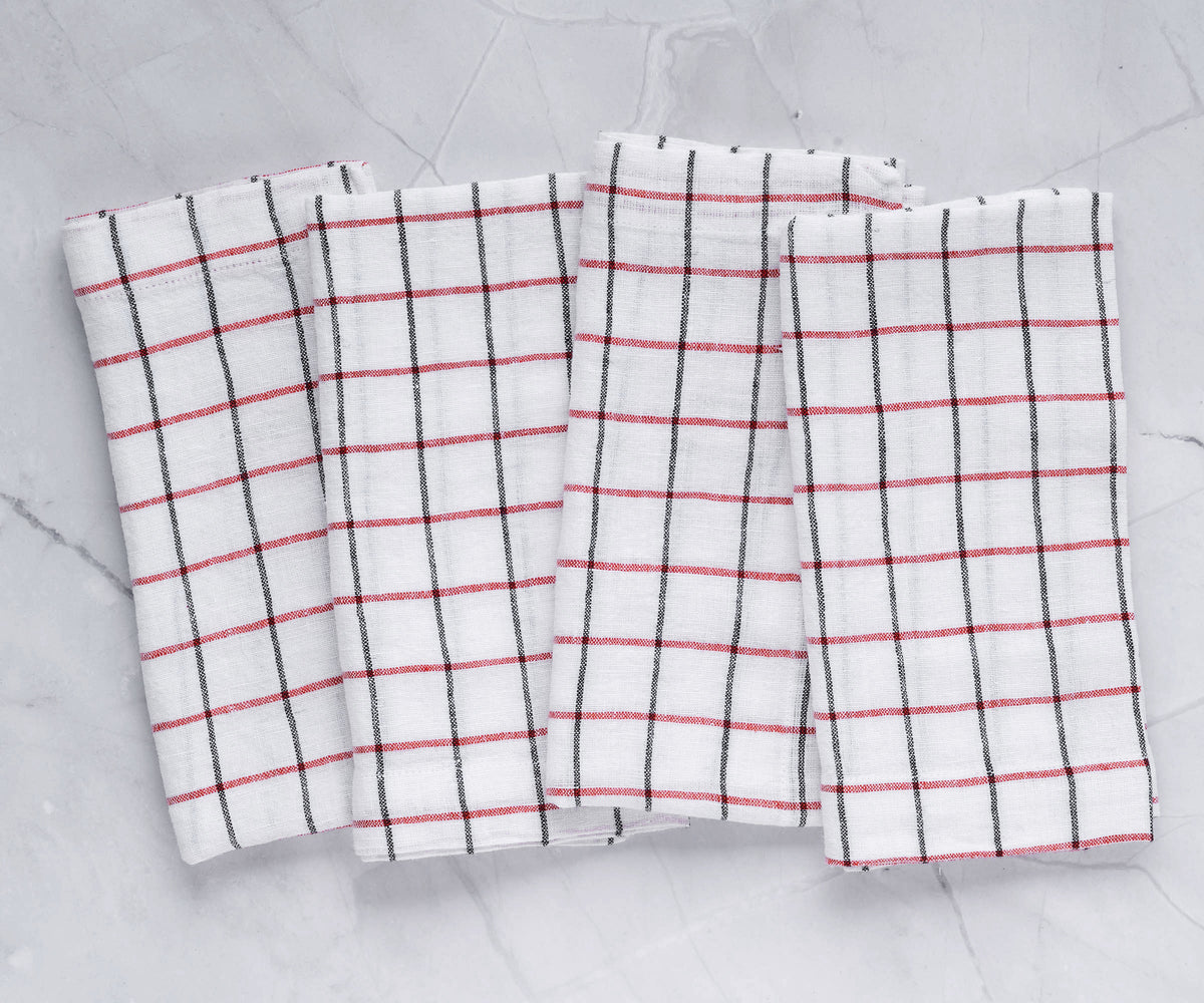A set of white napkins specifically designed for weddings, neatly folded on a table. A set of white napkins specifically designed for weddings, neatly folded on a table.