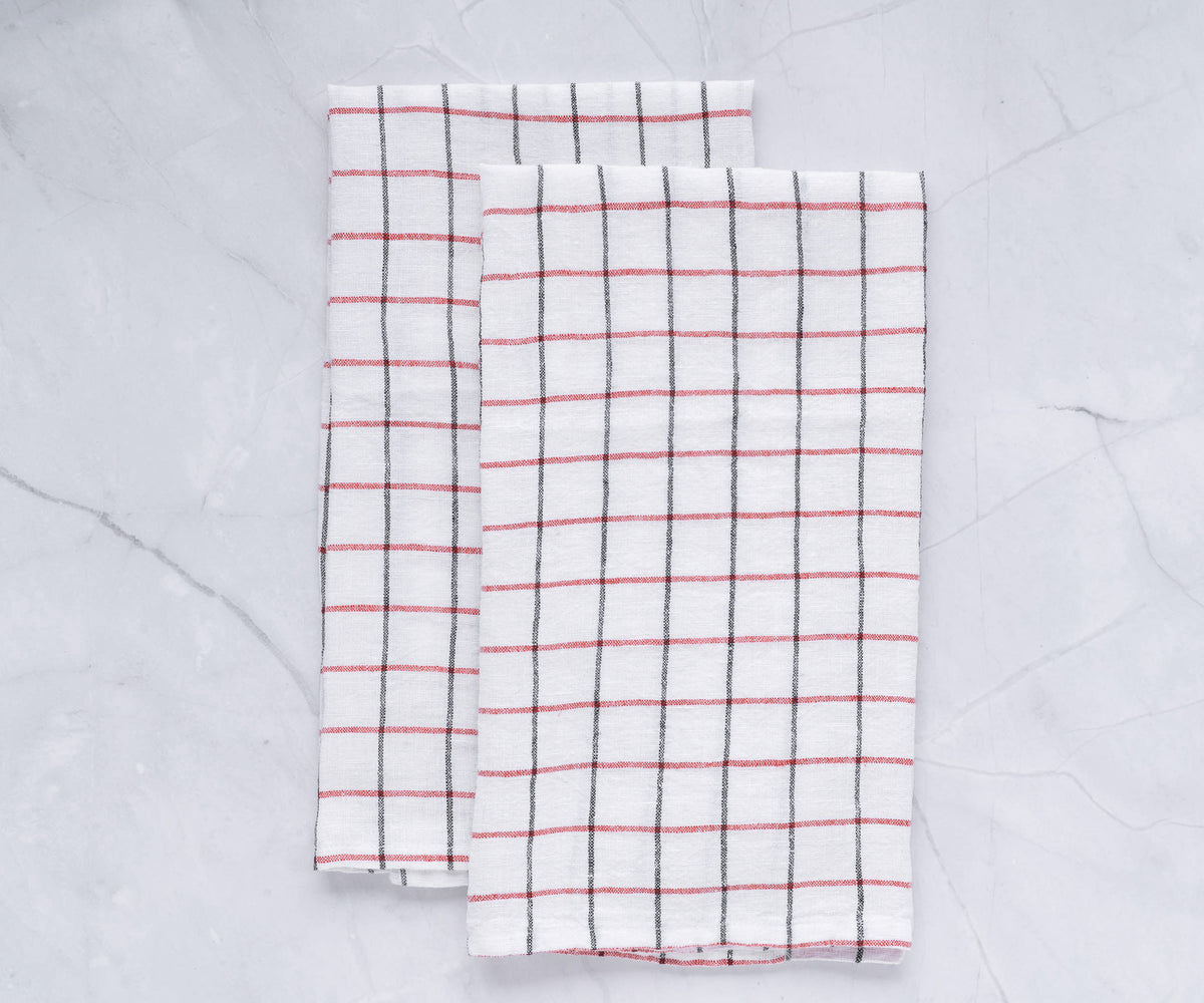 Simple, natural-colored linen kitchen towel hanging beside a stove. Practical and stylish for everyday kitchen use. Simple, natural-colored linen kitchen towel hanging beside a stove. Practical and stylish for everyday kitchen use.