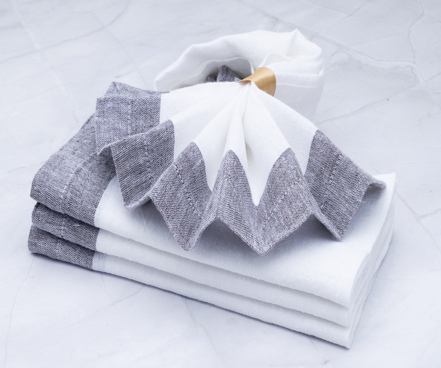 Soft linen dinner napkins displayed on dining table Soft linen dinner napkins displayed on dining table