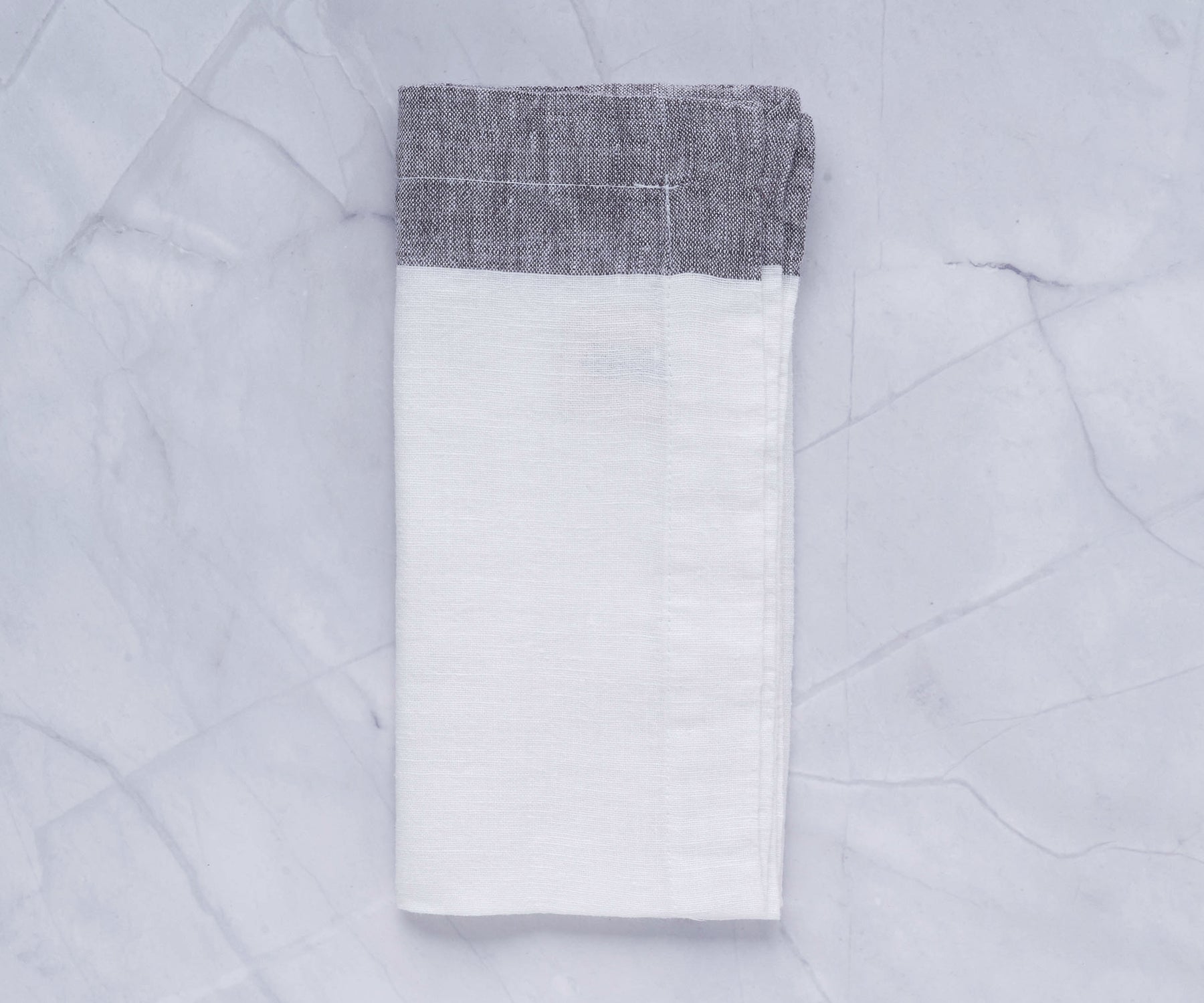 Pile of neatly stacked cloth dinner napkins in soft colors Pile of neatly stacked cloth dinner napkins in soft colors