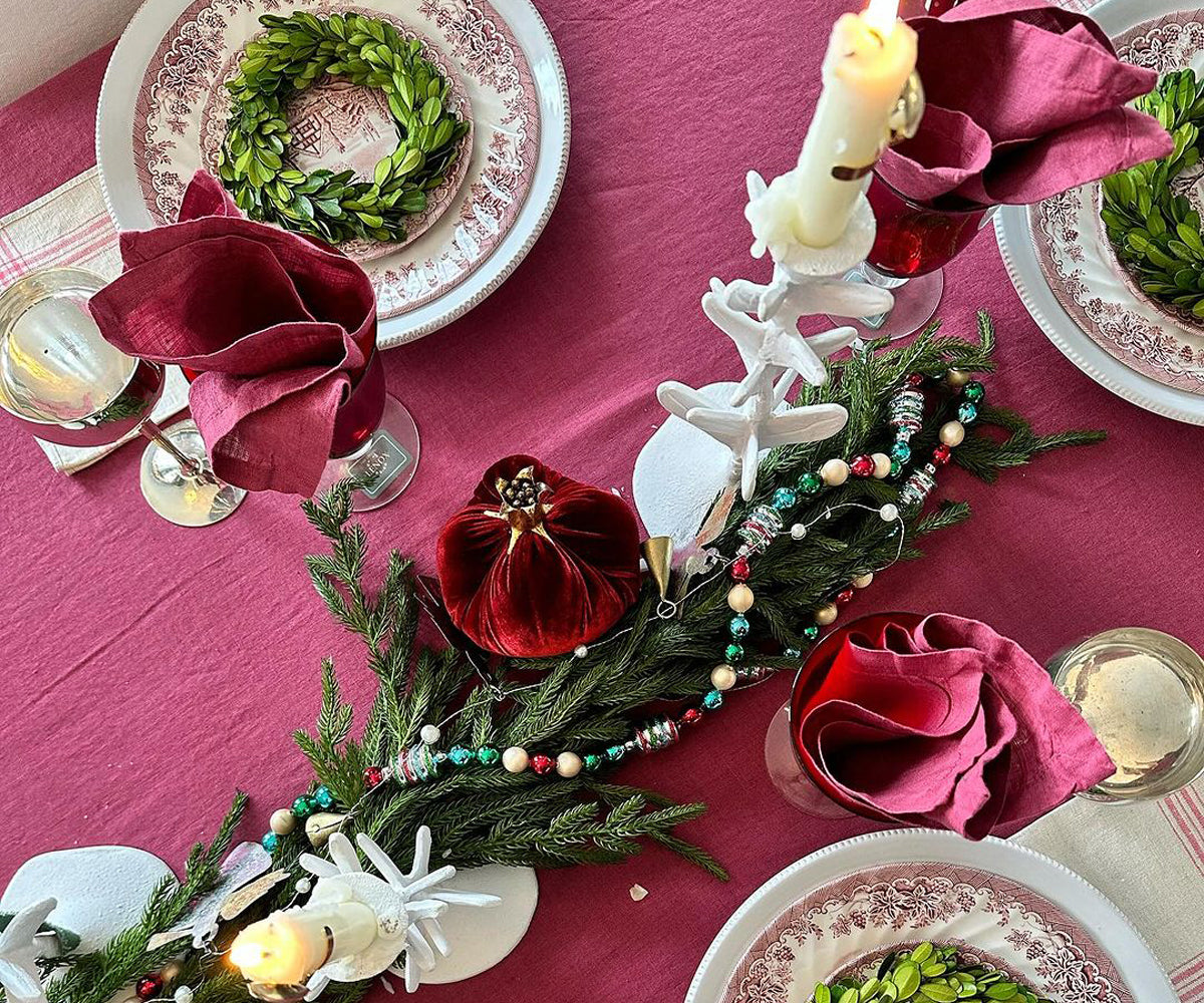 A gorgeous fuchsia-colored tablecloth adorned with roses, adding a touch of romance and elegance to the wedding table.